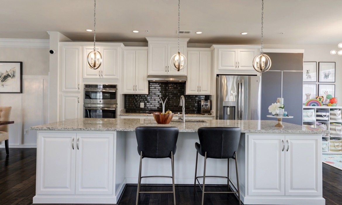 Contemporary kitchen in Ashburn townhouse with luxurious island and lighting