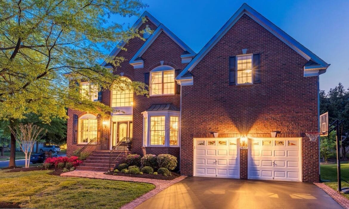 Luxury single family home in Ashburn with brick facade and landscaped yard, listed by top Ashburn Realtor Jean Garrell