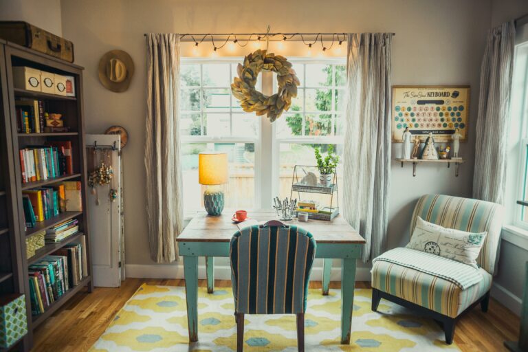 A cozy home office featuring a farmhouse-style desk and a vibrant yellow rug, exuding charm and comfort.