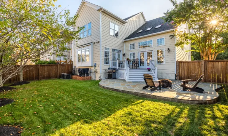 Beautiful backyard of Leesburg home with patio, deck, and lawn