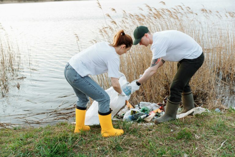 A man and woman work together to clean up garbage along the water as part of a volunteer environmental initiative in Loudoun County. Their efforts contribute to keeping the county's natural areas safe, clean, and beautiful for residents and wildlife alike.