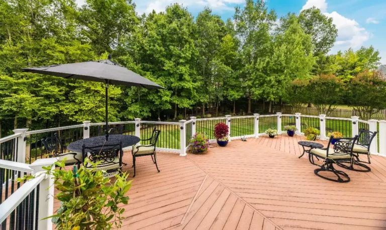 Outdoor living area featuring a deck and manicured lawn backing to trees at a Leesburg real estate listing sold by Jean Garrell. This inviting space highlights the value of curb appeal and outdoor amenities for Loudoun County buyers.