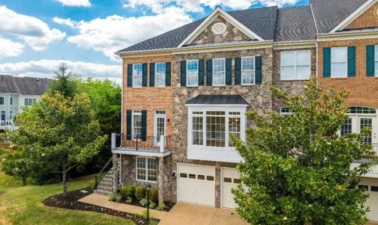 Townhome exterior during the day with beautiful stone siding, sold in Leesburg by top real estate agent team Garrell Group