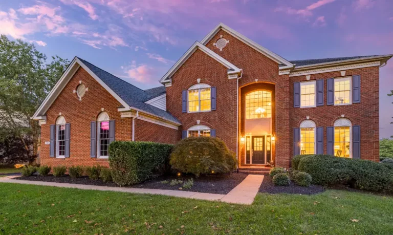 Luxury home exterior with brick and plantation shutters, representing the best time to sell your home in Ashburn VA