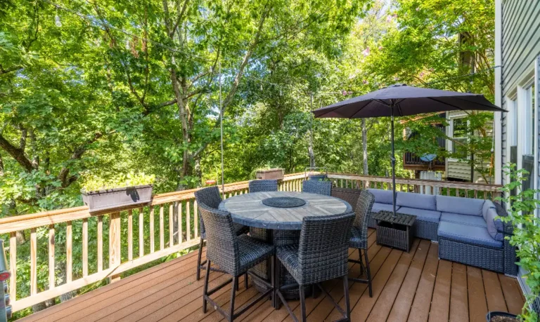 Backyard deck of a Sterling real estate home with views of trees, by top local real estate agents Garrell Group