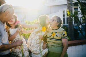 Grandchildren kissing their grandparents for whom it is their best time to sell a home in Ashburn Virginia for retirement and downsizing, by the top local Realtors Jean Garrell Group real estate agents